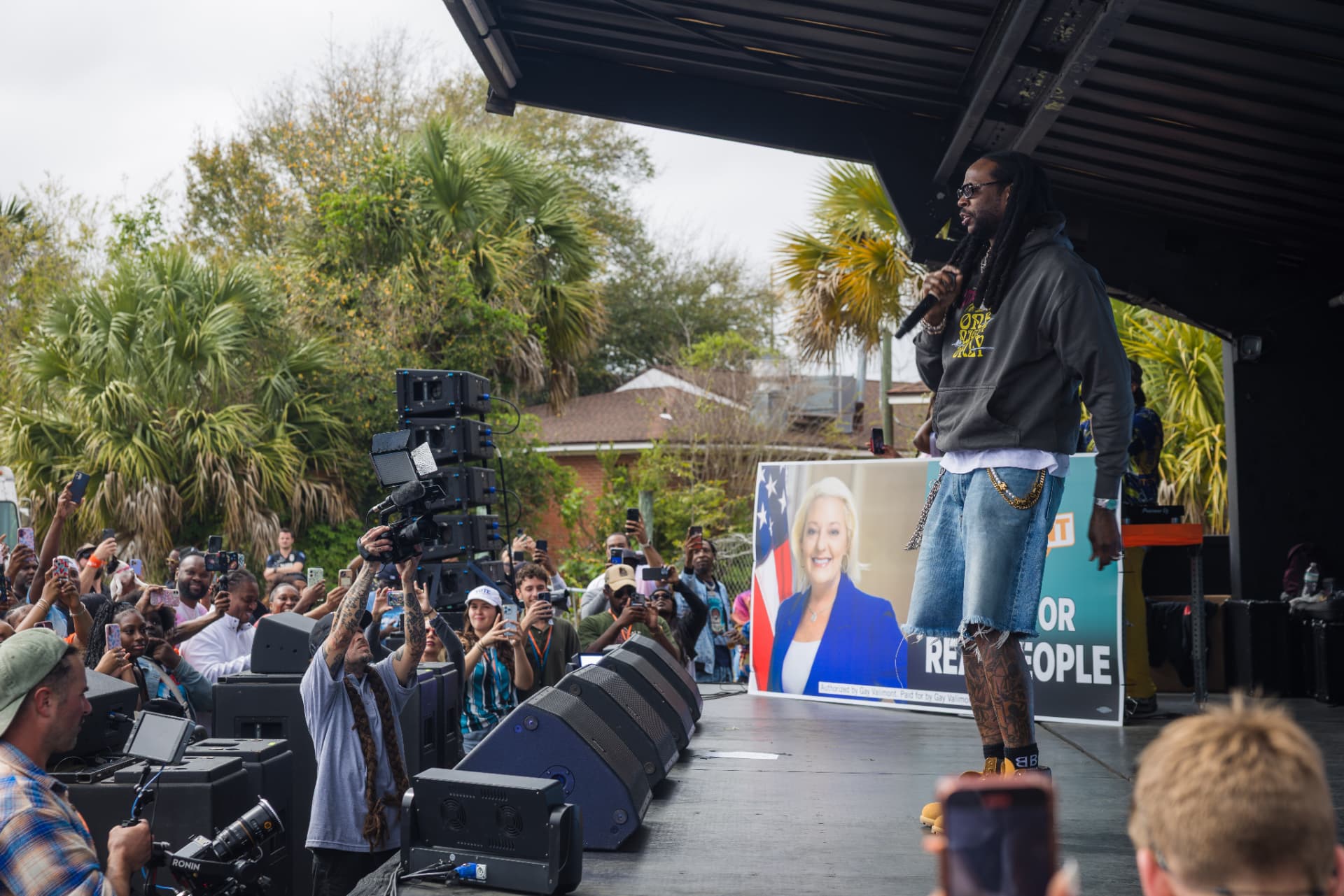 Press and supporters filming 2 Chainz at a campaign rally